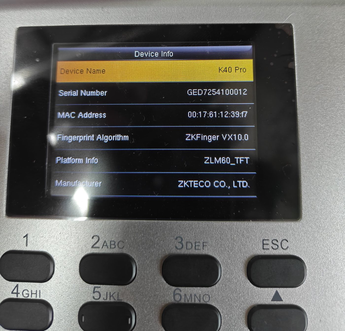 A ZKTeco K40 Pro biometric attendance device showing its Device Info screen, one menu step away from the network settings used to connect it to a computer