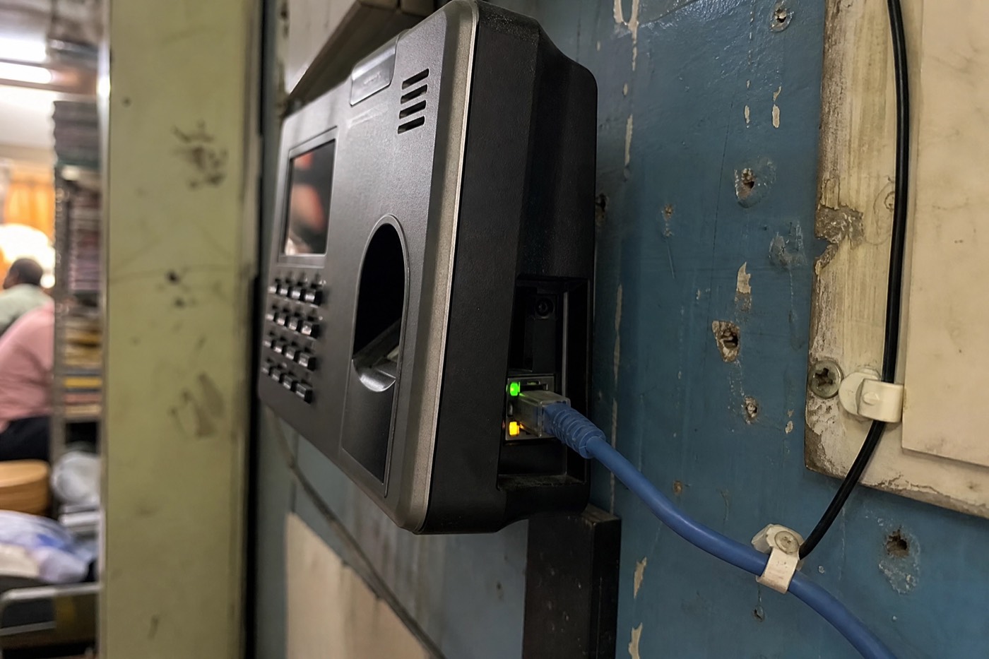 LAN cable connected to a biometric attendance device with active link lights